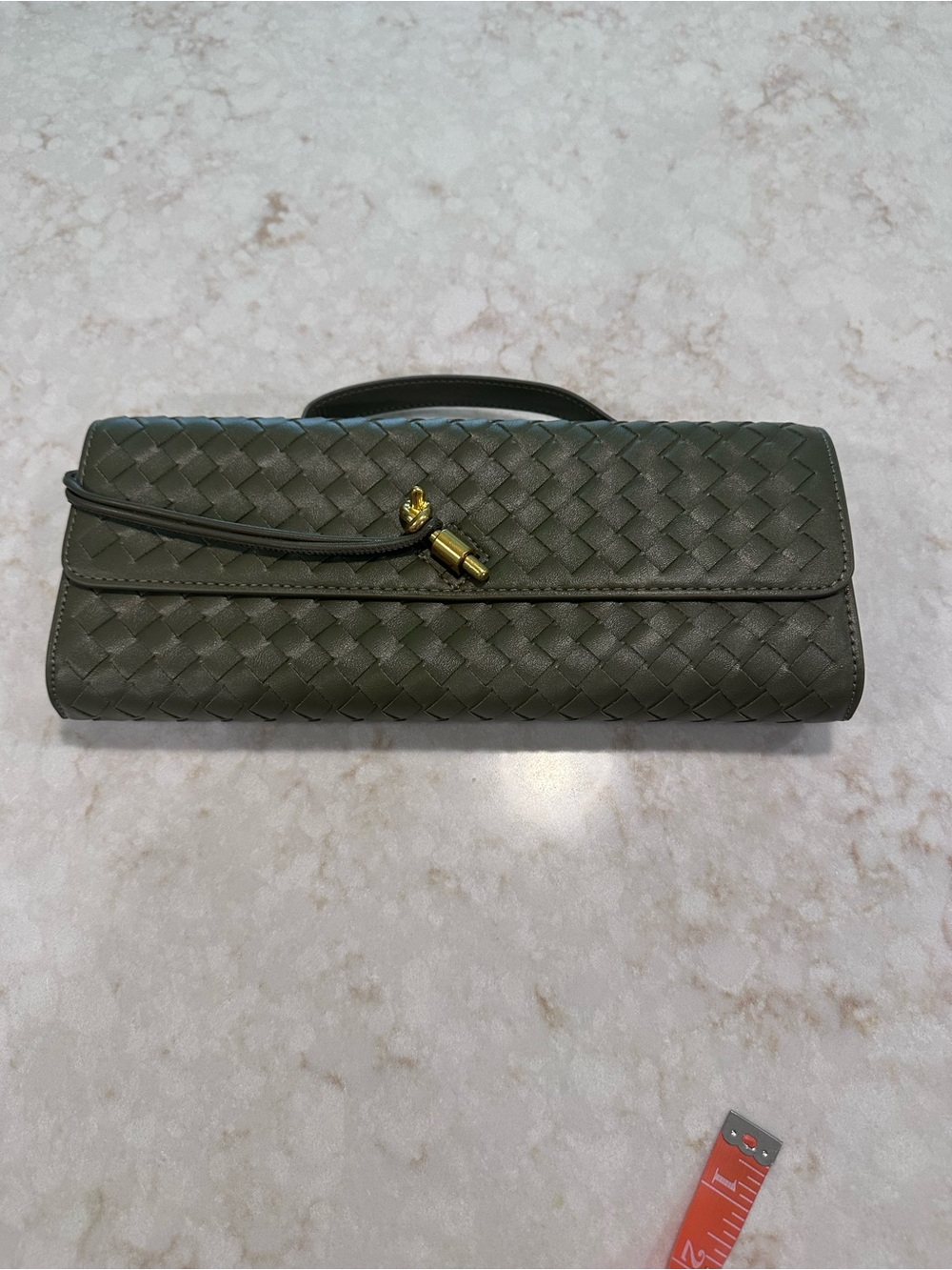 NWOT faux leather clutch with shoulder strap.